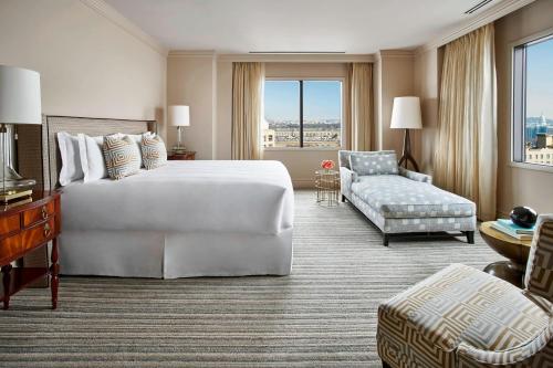 a hotel room with a large bed and a couch at The Ritz Carlton, Pentagon City in Arlington