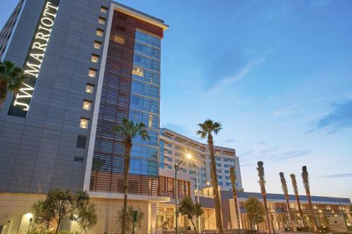 a tall building with palm trees in front of it at JW Marriott, Anaheim Resort in Anaheim
