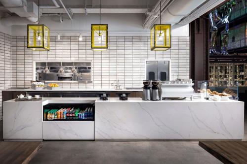 a kitchen with a white counter and some lights at JW Marriott Savannah Plant Riverside District in Savannah