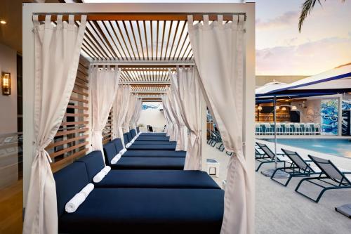 a wedding aisle with white curtains and blue seats next to a pool at JW Marriott Savannah Plant Riverside District in Savannah