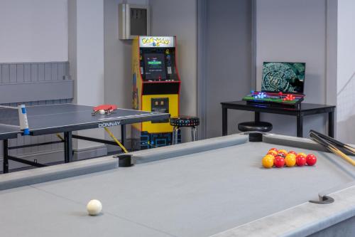 a ping pong table with balls and a video game at Stratford Manor Hotel in Stratford-upon-Avon