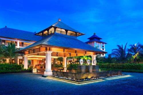 a resort with a large building at night at The St. Regis Bali Resort in Nusa Dua