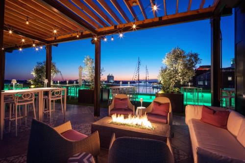 a patio with a fire pit and a bar at JW Marriott Savannah Plant Riverside District in Savannah