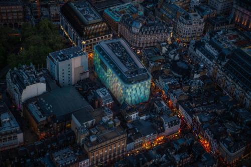 an overhead view of a city at night at W London in London