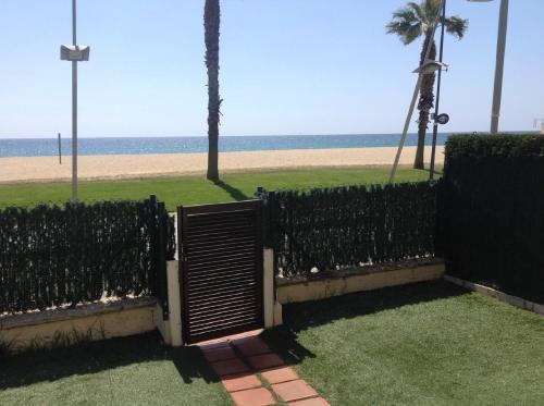 a black fence with a beach in the background at Valentina Platja in Sant Antoni de Calonge
