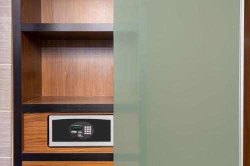 a microwave in a cabinet in a room at Aloft Orlando Downtown in Orlando