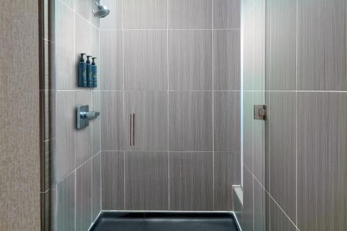 a bathroom with a shower with a glass door at Aloft Orlando Downtown in Orlando