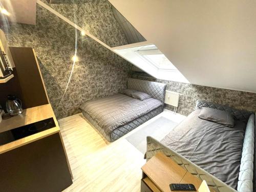 a small room with a bed and a couch at Alanga apartments in Palanga
