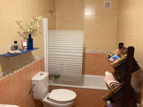 La salle de bains est pourvue d'une douche, de toilettes et d'une baignoire. dans l'établissement Coqueto y acogedor apartamento con piscina, à Roquetas de Mar