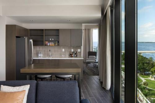 a kitchen and living room with a view of the ocean at Luminary Hotel & Co., Autograph Collection in Fort Myers
