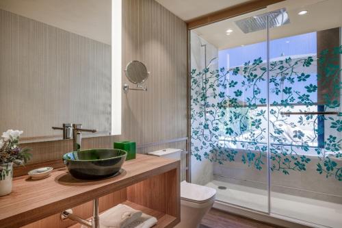 a bathroom with a sink and a shower at Querencia de Sevilla, Autograph Collection in Seville