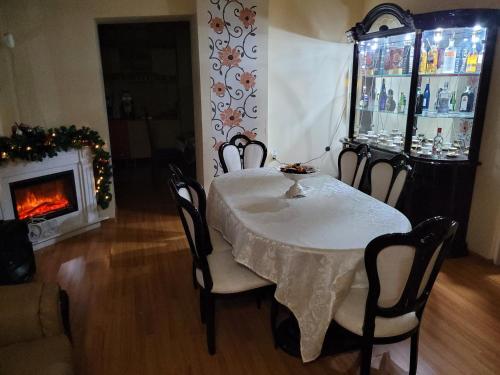 a dining room with a table and chairs and a fireplace at Casa Ovi și Simo in Haţeg