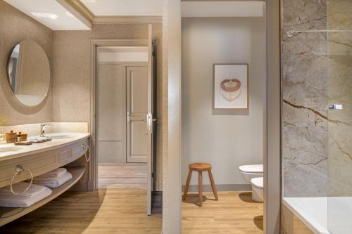 a bathroom with a sink and a toilet at Hacienda Son Antem Golf Resort, Autograph Collection in Llucmajor