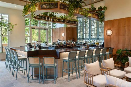 a bar in a restaurant with stools at JW Marriott Orlando Grande Lakes in Orlando
