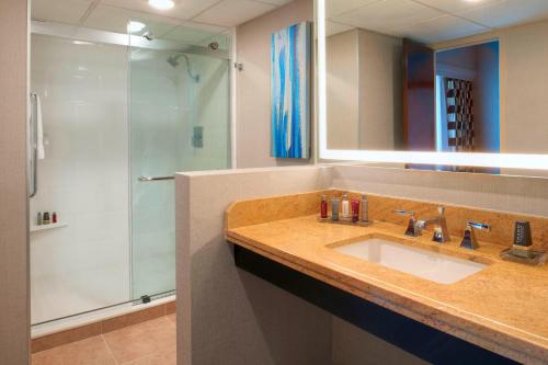 a bathroom with a sink and a shower at Kansas City Airport Marriott in Kansas City