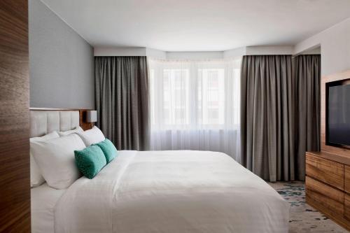 a hotel room with a large bed and a television at Vienna Marriott Hotel in Vienna
