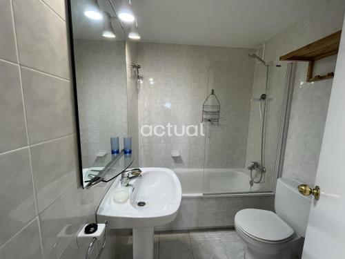 a bathroom with a sink and a toilet and a tub at ACAPULCO 1-4 in Platja d'Aro