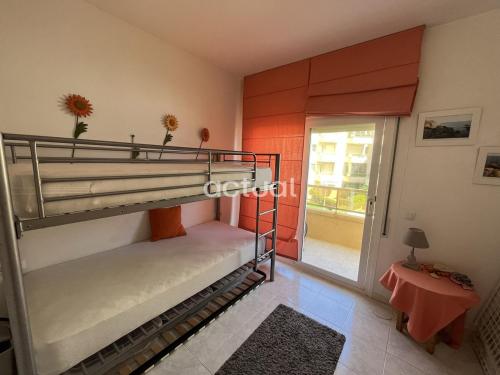 a bedroom with two bunk beds in a room at ACAPULCO 1-4 in Platja d'Aro