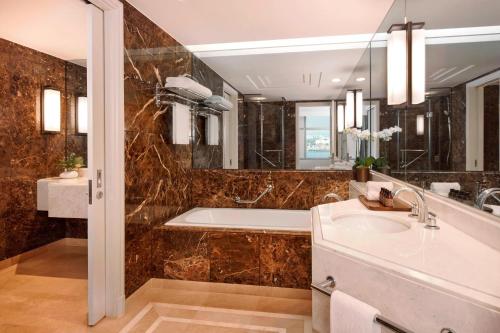 a bathroom with a tub and a sink at JW Marriott Hotel Seoul in Seoul
