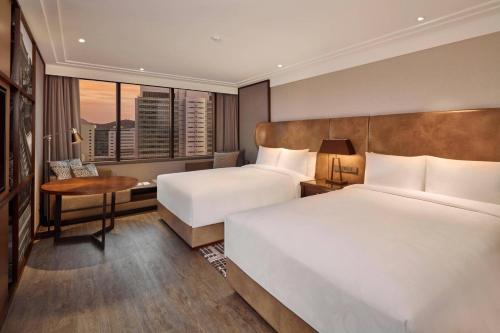 a hotel room with two beds and a desk at JW Marriott Hotel Seoul in Seoul