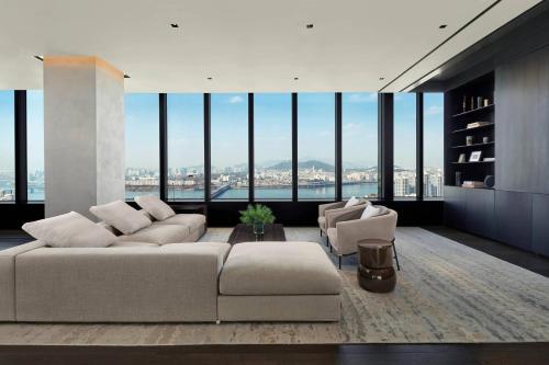 a living room with a large couch and chairs at JW Marriott Hotel Seoul in Seoul
