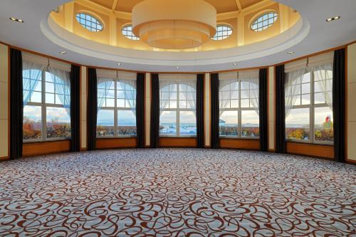 a large ballroom with windows and a large ballasteryasteryasteryasteryasteryastery at Sheraton Sopot Hotel in Sopot