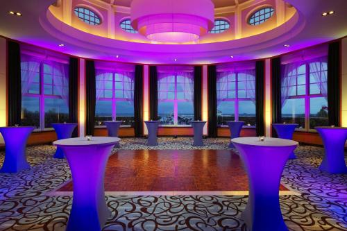 a ballroom with purple tables and windows at Sheraton Sopot Hotel in Sopot