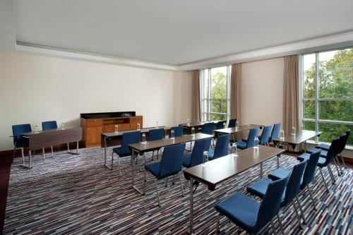 a conference room with tables and chairs and a piano at Sheraton Sopot Hotel in Sopot