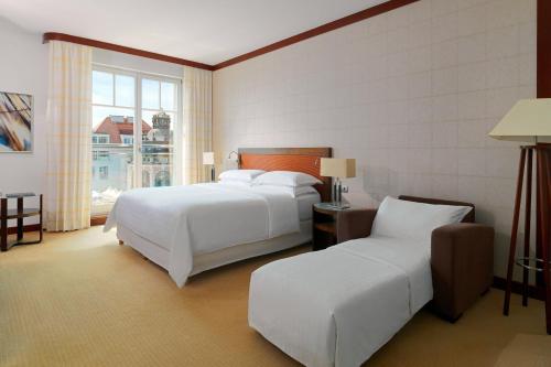 a hotel room with two beds and a window at Sheraton Sopot Hotel in Sopot