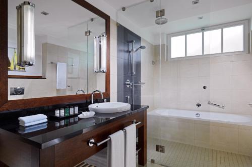 a bathroom with a sink and a shower and a tub at Sheraton Sopot Hotel in Sopot