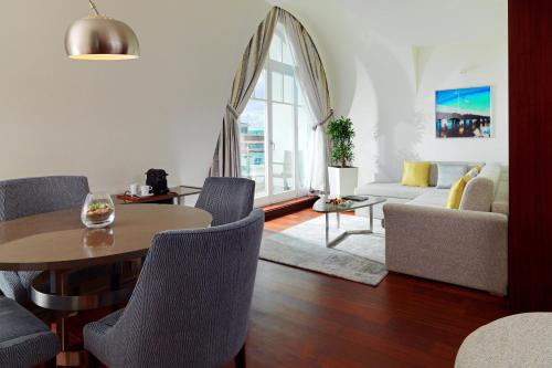 a living room with a table and a couch at Sheraton Sopot Hotel in Sopot