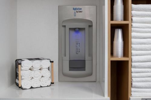a paper towel dispenser with a pile of towels at Courtyard by Marriott Santa Cruz in Santa Cruz
