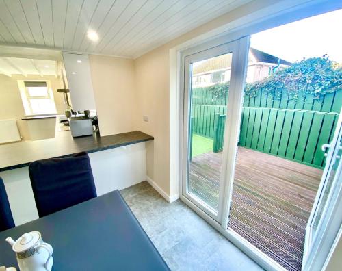 an office with a desk and a sliding glass door at Mountain Dream Ramsey Isle of Man in Ramsey