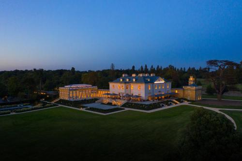 an aerial view of a large building with lights on at The Langley, a Luxury Collection Hotel, Buckinghamshire in Iver