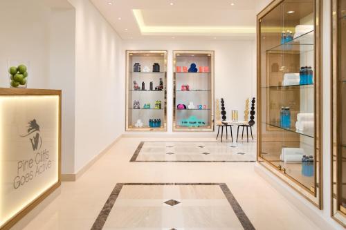 a store hallway with glass doors and a table at Pine Cliffs Residence, a Luxury Collection Resort, Algarve in Albufeira