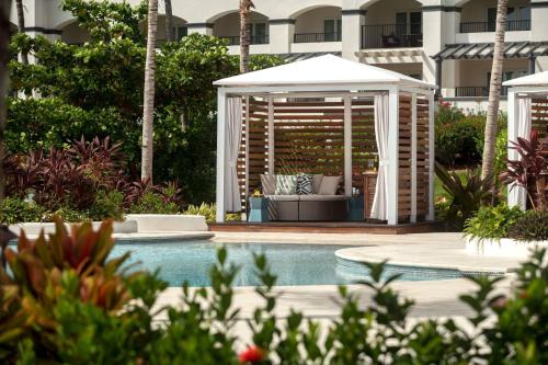 a pool with a gazebo next to a building at The Ritz-Carlton St. Thomas in Benner