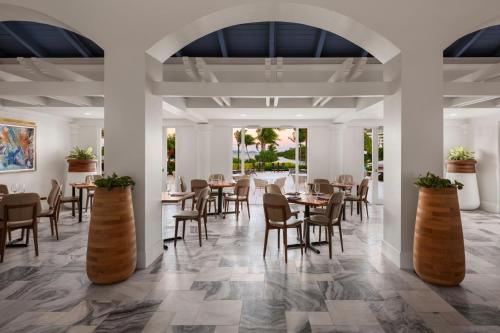 a dining room with tables and chairs and an archway at The Ritz-Carlton St. Thomas in Benner