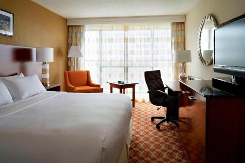 a hotel room with a bed and a television at Ottawa Marriott Hotel in Ottawa