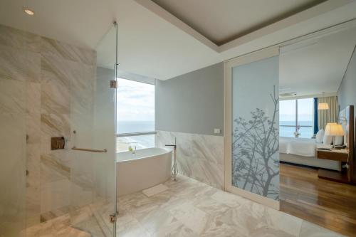 a bathroom with a tub and a glass shower at Hotel InterContinental Cartagena, an IHG Hotel in Cartagena de Indias