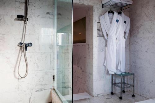 a shower in a bathroom with a glass shower stall at AC Hotel Ciudad de Sevilla by Marriott in Seville