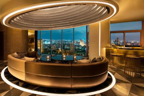 a living room with a couch and a large window at W Mexico City in Mexico City