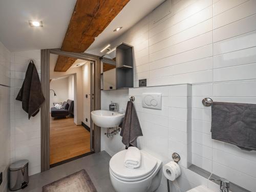a bathroom with a toilet and a sink at LA SCALA MATTA - Seaview Penthouse in La Spezia