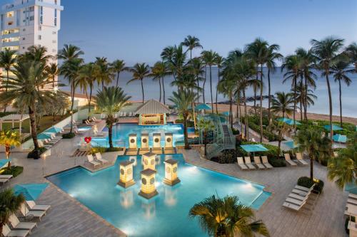 an overhead view of a resort pool with palm trees at San Juan Marriott Resort and Stellaris Casino in San Juan