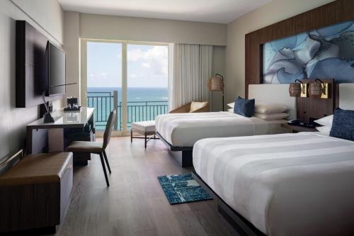 Pokój hotelowy z 2 łóżkami i biurkiem w obiekcie San Juan Marriott Resort and Stellaris Casino w mieście San Juan