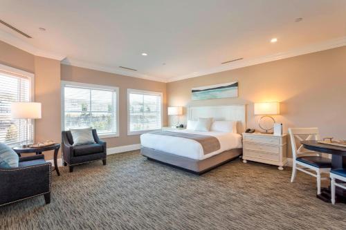 a bedroom with a bed and a desk and a chair at Inn at Bay Harbor, Autograph Collection in Petoskey