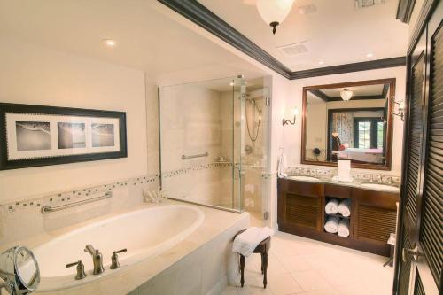 a bathroom with a tub and a shower and a sink at Scrub Island Resort, Spa & Marina in The Mill