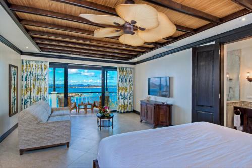 a bedroom with a bed and a ceiling fan at Scrub Island Resort, Spa & Marina in The Mill