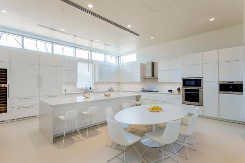a large white kitchen with a white table and chairs at St. Regis Bahia Beach Resort, Puerto Rico in Rio Grande