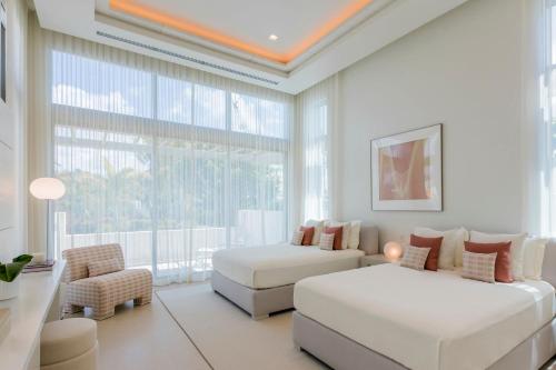 a living room with two beds and a couch at St. Regis Bahia Beach Resort, Puerto Rico in Rio Grande