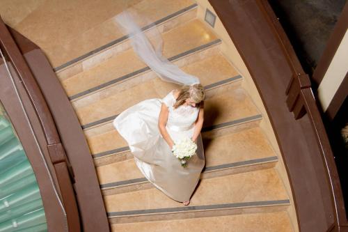 a bride in her wedding dress holding a bouquet at Scrub Island Resort, Spa & Marina in The Mill